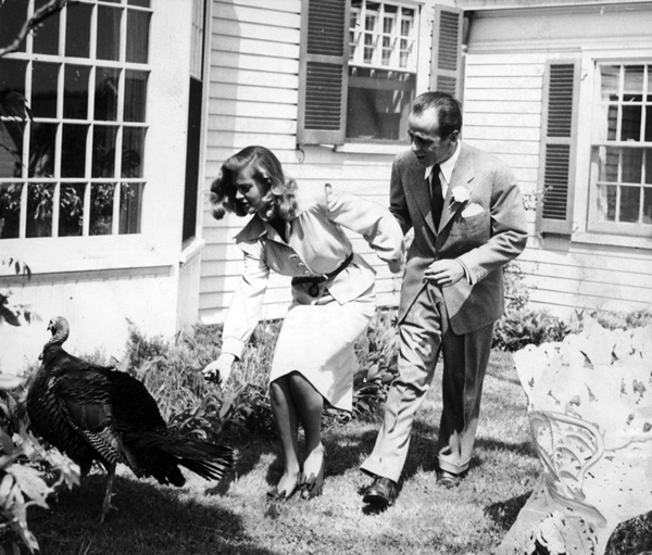 Turkey Day Greeting: Bogie and Bacall chat up a turkey