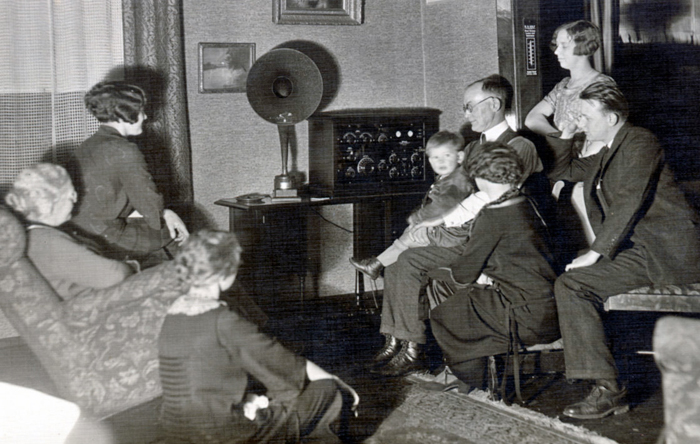 A family gathers around to listen to Cladrite Radio