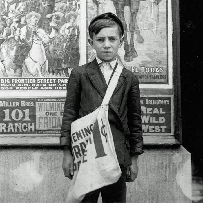 a 1915 photograph of a young newsboy announcing Cladrite Radio App